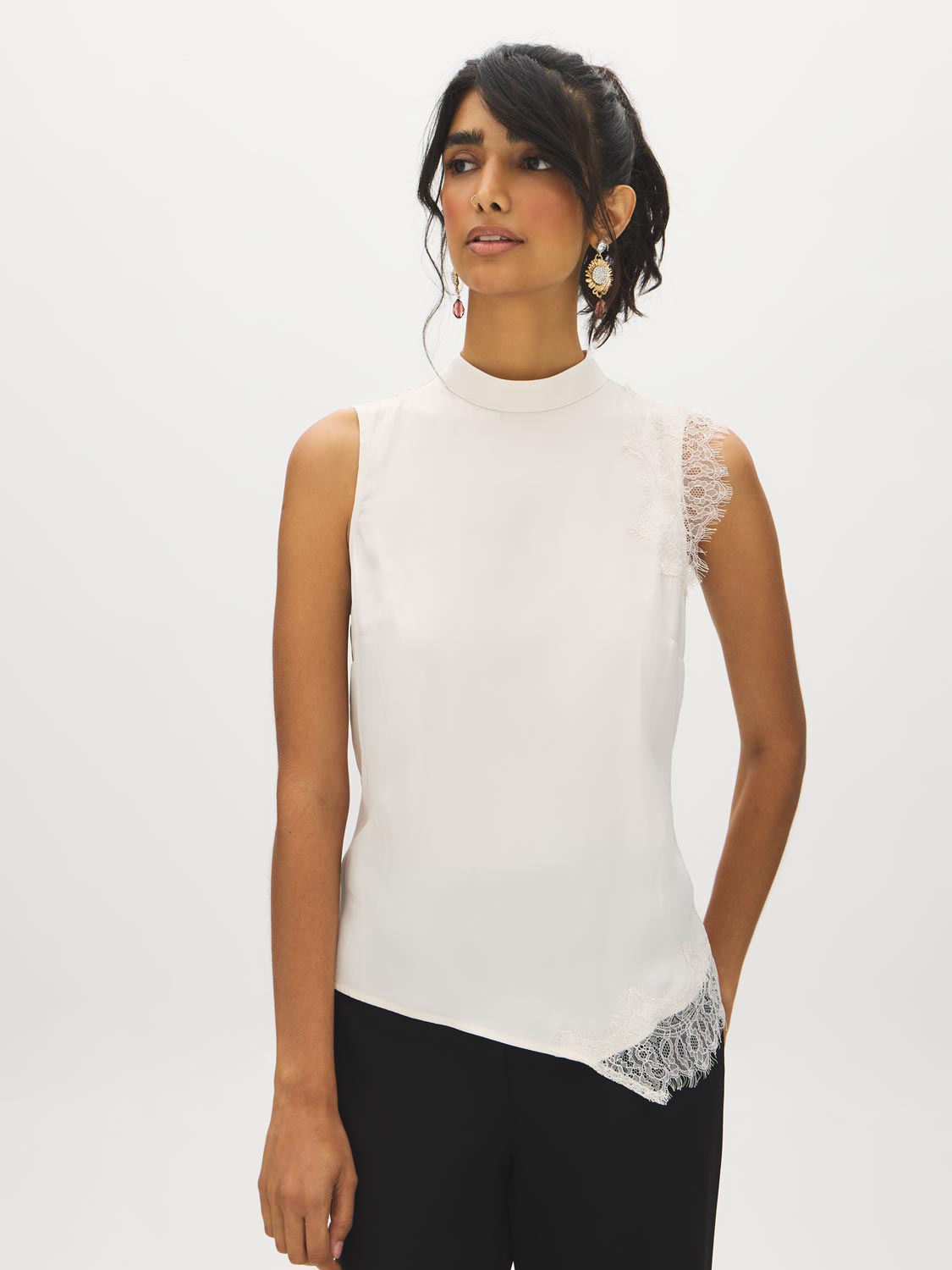 Winter White Sleeveless Mock Neck Blouse with Lace Inserts - Woman Wearing Asymmetrical Hem Top - Suzy Shier