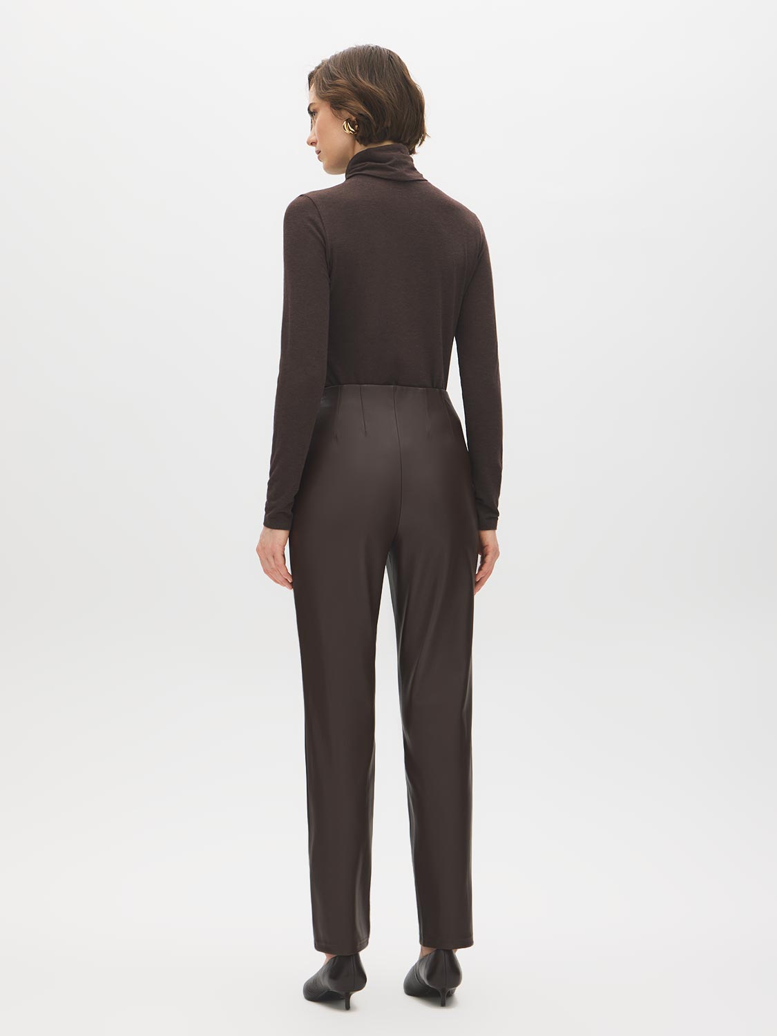 Coffee Bean Faux Leather Slim Leg Pull-On Pant - Woman Wearing Sleek Faux Leather Trousers - Suzy Shier
