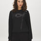 Jet Black Sequin Bow Detail Knit Top - Woman Wearing Long Sleeve Hacci Top - Suzy Shier