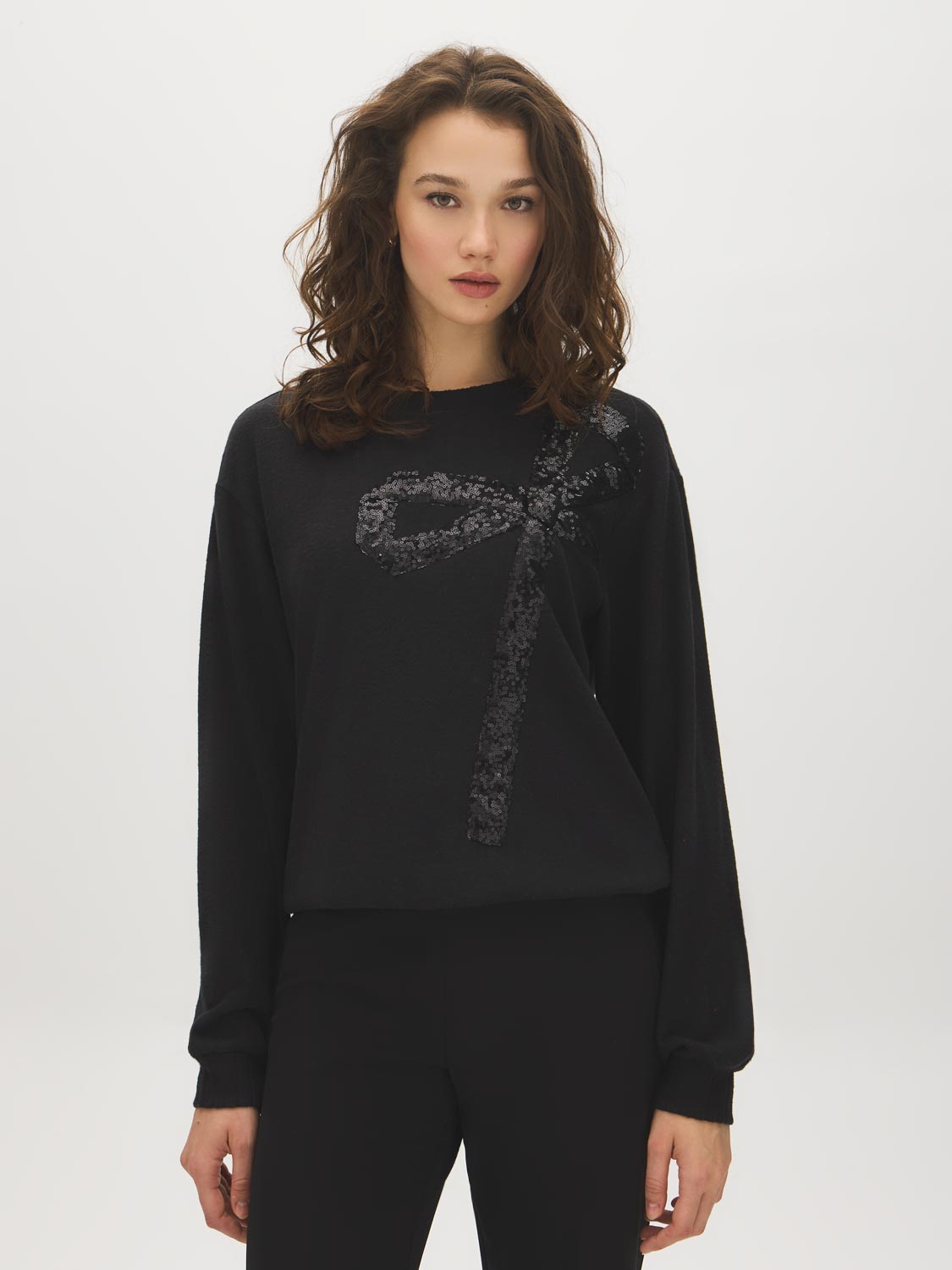 Jet Black Sequin Bow Detail Knit Top - Woman Wearing Long Sleeve Hacci Top - Suzy Shier