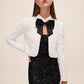 Black and Antique Cream Sequin Bolero with Puffy Sleeves - Front View with Bow - Le Chateau