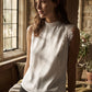 Winter White Sleeveless Mock Neck Blouse with Lace Inserts - Woman Wearing Asymmetrical Hem Top - Suzy Shier