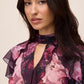 Eggplant Floral Keyhole Ruffle Blouse - Close-up Fabric Detail - Le Chateau