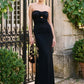 Black Strapless Gown with Rosette Trim - Woman Wearing Elegant Evening Dress with Side Slit - Le Chateau