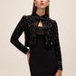 Black and Antique Cream Sequin Bolero with Puffy Sleeves - Woman Wearing Evening Cover-Up with Removable Bow - Le Chateau