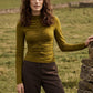 Guacamole Mock Neck Jersey Top with Ruched Detail - Front View - Suzy Shier