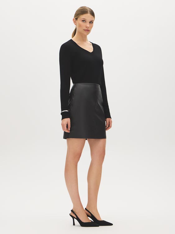 Black Faux Leather Mini Skirt with Back Zipper - Woman Wearing Sleek Polyurethane Skirt - Suzy Shier