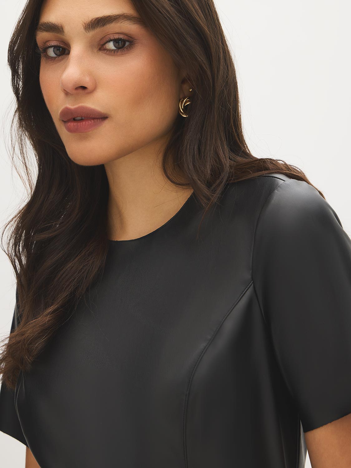 Jet Black Mini Faux Leather Dress with Belted Waist - Close-up Fabric Detail - Suzy Shier