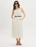 Snow White Polka Dot Flowy Midi Dress - Woman Wearing Spaghetti Strap Dress with Belt - Suzy Shier