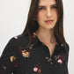 Black Floral Printed Peplum Blouse with Drawstring Waist - Close-up Fabric Detail - Suzy Shier