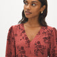 Apple Butter Printed Crinkle Satin Peplum Blouse - Close-up Fabric Detail - Suzy Shier
