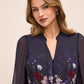 Dark Sapphire Border Floral Midi Dress with Puff Sleeves - Close-up Split Neckline Detail - Le Chateau