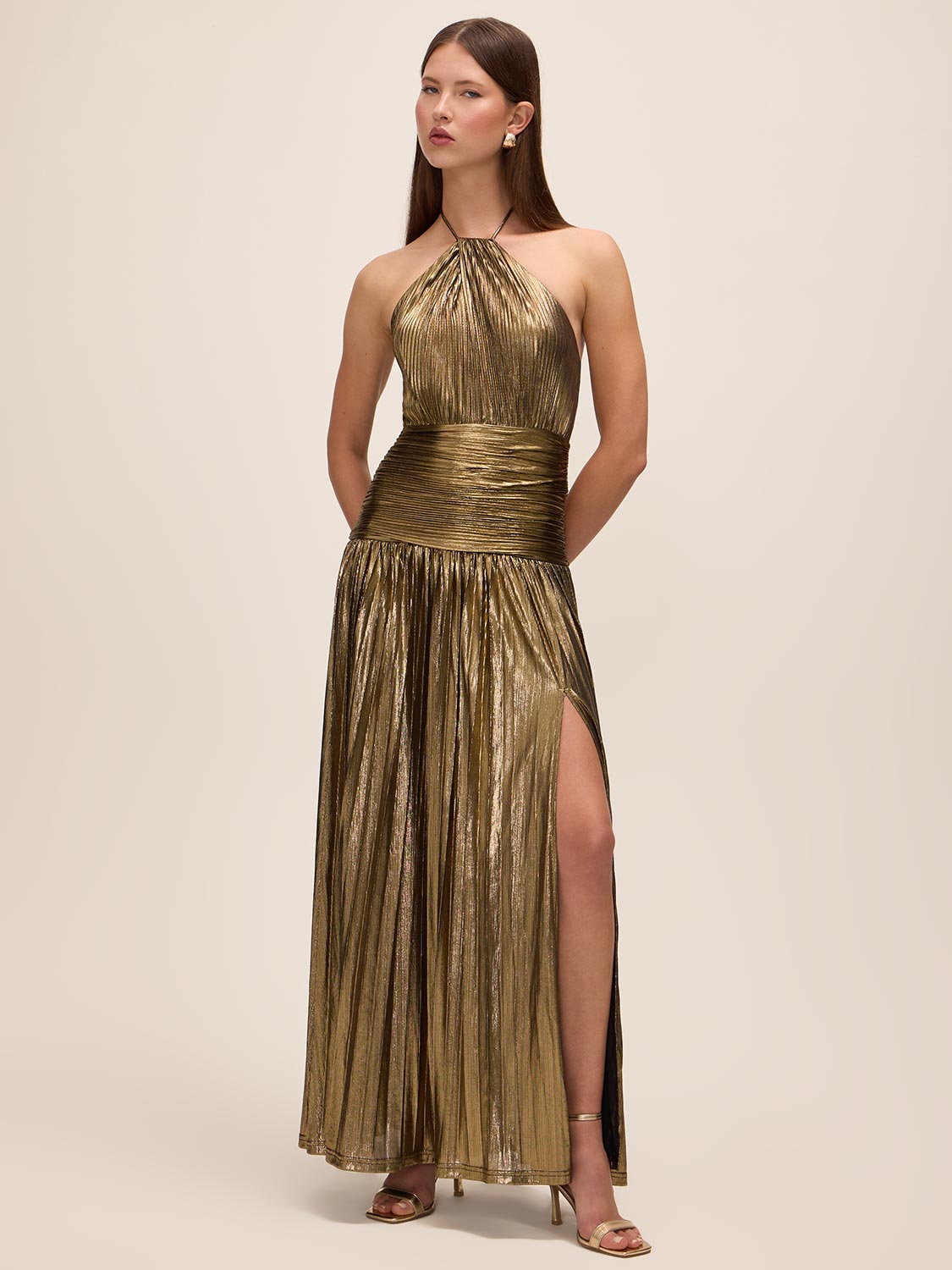 Bronze Liquid Stripe Foil Gown - Woman Wearing Halter Neck Dress with Pleated Skirt - Le Chateau