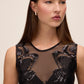 Black Sequin Mesh Illusion Jumpsuit - Close-up Neckline Detail - Le Chateau