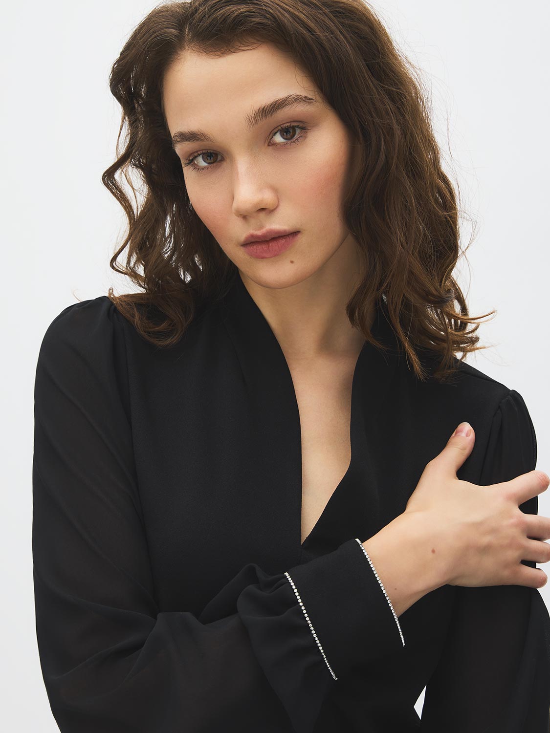 Jet Black V-Neck Top with Chiffon Sleeves and Rhinestone Cuffs - Close-up Cuff Detail - Suzy Shier