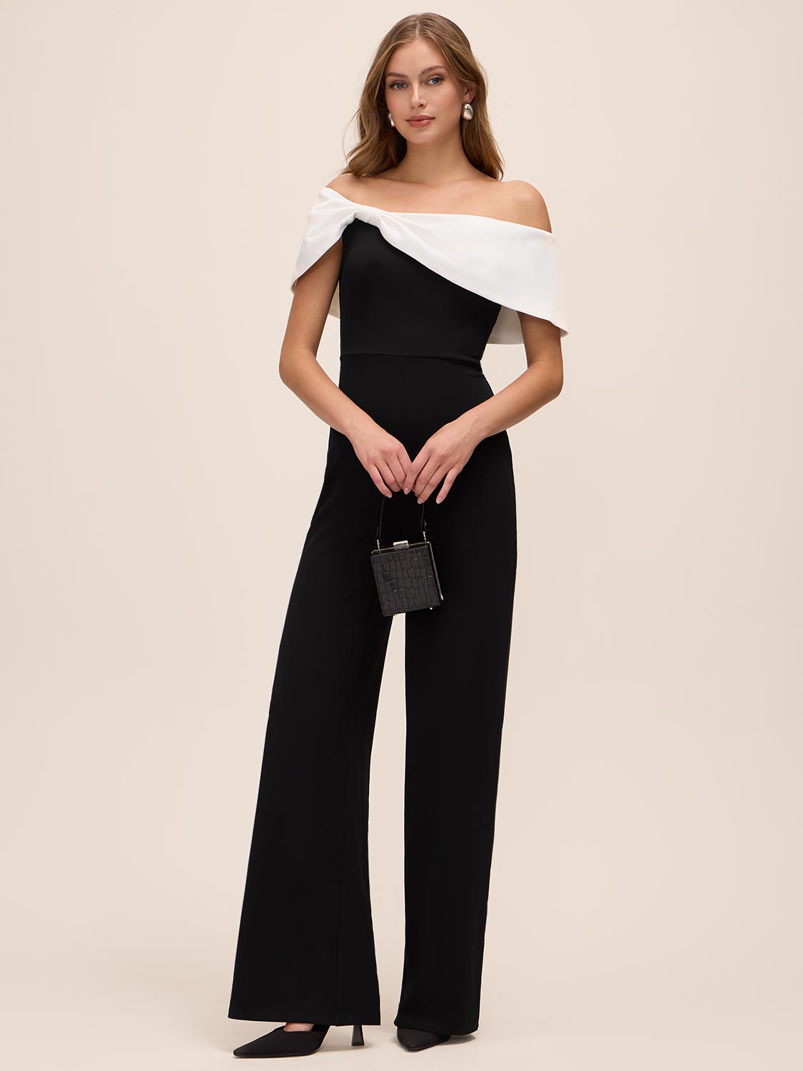 Black/White Asymmetrical Off-Shoulder Knit Jumpsuit - Woman Wearing Elegant Jumpsuit with Satin Bow - Le Chateau