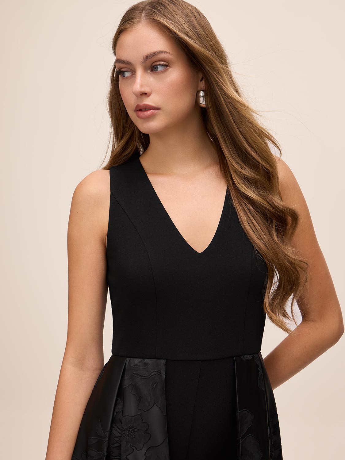 Black V-Neck Jumpsuit with Jacquard Skirt Overlay - Close-up V-Neckline Detail - Le Chateau