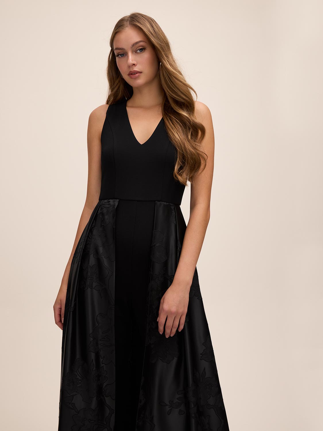 Black V-Neck Jumpsuit with Jacquard Skirt Overlay - Side Profile View - Le Chateau