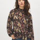 Black Paisley Mock Neck Top with Ruffle Hem - Woman Wearing Long Sleeve Patterned Blouse - Suzy Shier