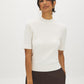 Snow White Mock Neck Cable Knit Sweater - Woman Wearing Textured Knit Top - Suzy Shier