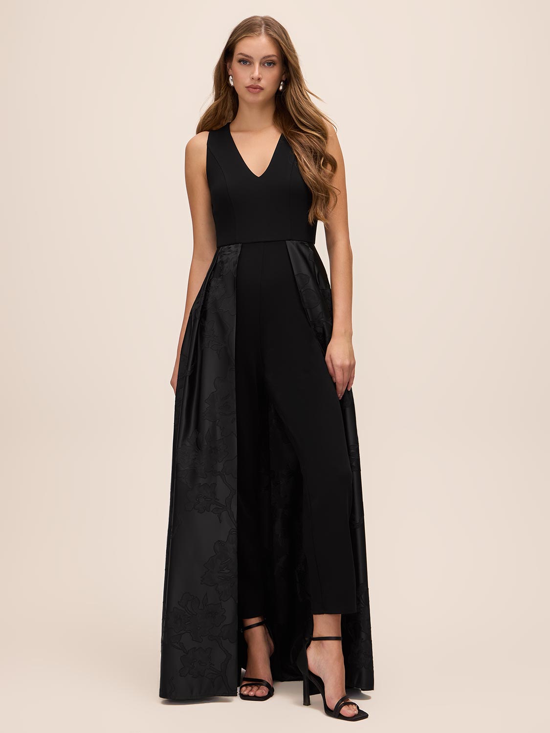 Black V-Neck Jumpsuit with Jacquard Skirt Overlay - Woman Wearing Elegant Eveningwear - Le Chateau