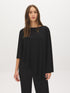 Jet Black Asymmetrical Knit Poncho Top - Woman Wearing Sweater-Cape Hybrid - Suzy Shier